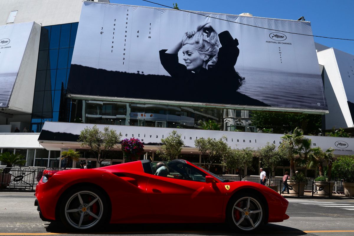 This picture taken on May 15, 2023 shows the official poster of the 76th Cannes Film Festival featuring a photograph of actress Catherine Deneuve by Jack Garofalo, on the facade of the Palais des Festivals in Cannes, southeastern France. Cannes Film festival will take place from May 16 to May 27. (Photo by Christophe SIMON / AFP) / RESTRICTED TO EDITORIAL USE - MANDATORY MENTION OF THE ARTIST UPON PUBLICATION - TO ILLUSTRATE THE EVENT AS SPECIFIED IN THE CAPTION